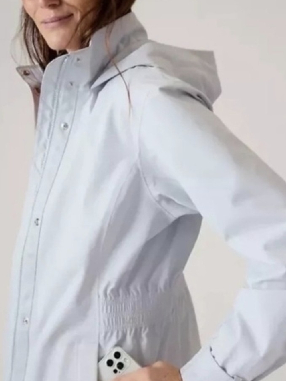 Athleta Cloudburst Water Repellent Jacket in a soft taupe or dove grey colorway.